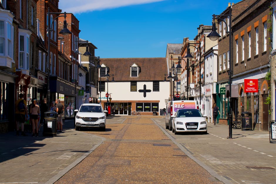 A white van is parked on the street outside a shop on Beckenham High Street, close to a no-parking traffic sign mounted on a pole. The van’s front door is visible, with the driver's window slightly aj